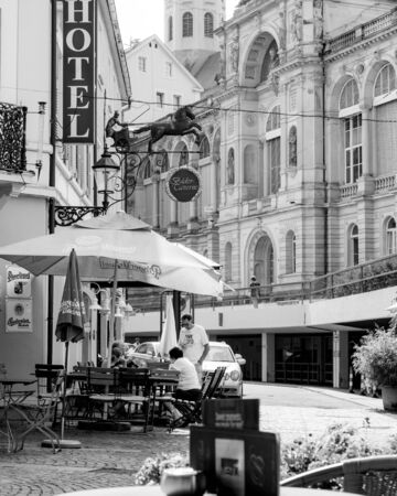 Baden-Baden, Germany - Jul 7, 2019: Outdoor terrace with customers people at the hotel with Bader Taverna and Friedrichsbad Baden-Baden, famous thermal baths - black and whiteのeditorial素材