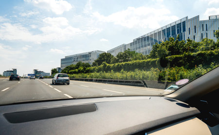 Paris, France - Jul 15, 2019: View from the car at wide office buildings headquarters with SFR icon...