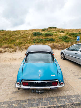 Overveen, Netherlands - Aug 16, 2019: Rear view of luxury vintage old blue Citroen D Special limousine parked in the sand covered Dutch paid parkingのeditorial素材