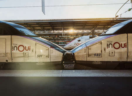 Paris, France - Oct 13, 2018: TGV In OUI fast Train a Grande Vitesse on the railroad platform with beautiful sunlight flareのeditorial素材