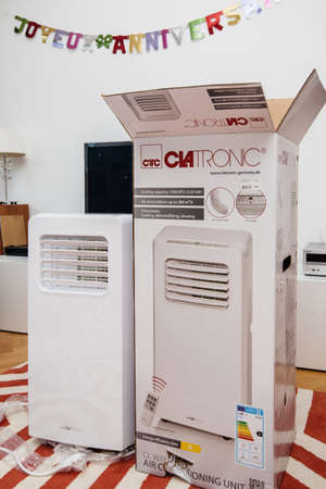 Paris, France - Jun 23, 2019: New new portable air conditioner unit AC during hot summer manufactured by Clatronic near his box after unpackingのeditorial素材