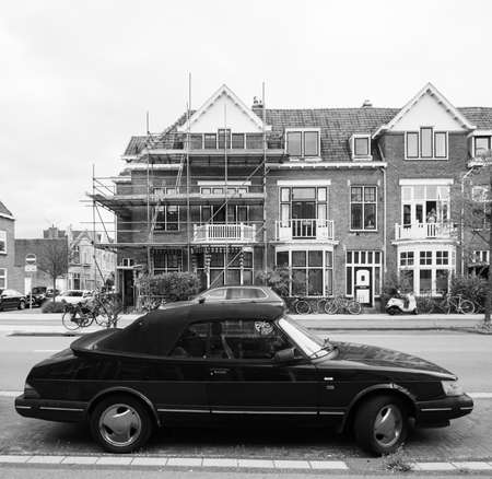 Haarlem netherlands - Aug 16 2018: Vintage cabrio SAAB car parked on the street in Dutch city with traditional architecture buildings in background black and whiteのeditorial素材