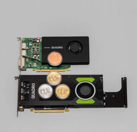 Paris, France - Aug 23, 2017: View from above of two nvidia Quadro professional GPU video cards with four bitcoins on the top of the cards P4000 and K2200 Paris, France - Aug 23, 2017: View from above of two nvidia Quadro professional GPU video cards with four bitcoins on the top of the cards P4000 and K2200