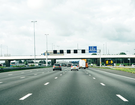 Netherlands - Aug 29, 2019: View from the car at the five lane highway in Dutch city approaching Den Ruygen Hoek station in 1000 metersのeditorial素材
