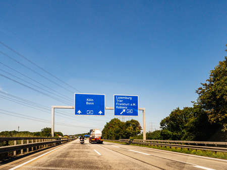 Germany - Aug 22, 2019: Koln, Bonn, Luxembourg, Trier, Frankfurt am Main and Koblenz city names on the highway signs in Germanyのeditorial素材