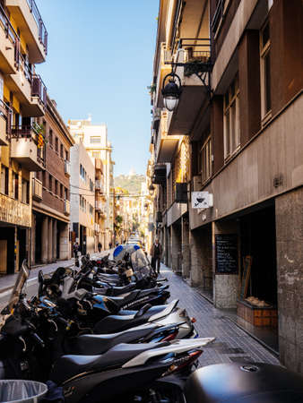 Barcelona, Spain - Nov 13, 2017: Multiple scooters moped parked in front of apartment building in central Barcelonaのeditorial素材