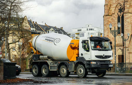 Strasbourg, France - Dec 15, 2017: Renault truck carrying Unibeton Italcementi Group concrete mixer driving on French city streetのeditorial素材