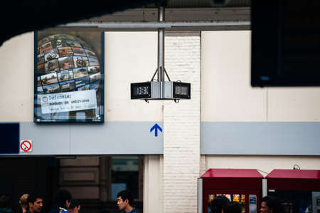 Ostend, Belgium - Jul 16, 2011: Public clock watch in Ostend railway station destination with digital display at the door to Antwerpen Centraal and Bruggeのeditorial素材