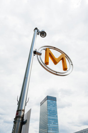 Paris, France - Jul 14, 2011: M sign for Parisian metropolitain in La Defense business district with skyscraper in backgroundのeditorial素材