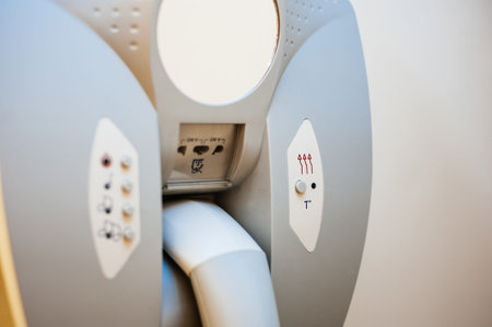 Close-up detail of hairdryer hanged on the wall of bathroom in modern hotel with power plug for the...