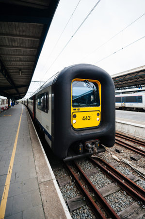 Ostend, Belgium - Jul 16, 2011: End of a traditional yellow Belgium train leaving Oostende railway...