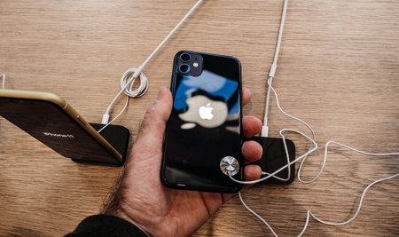 Paris, France - Sep 20, 2019: View from above of man hand holding black new iPhone 11 in Apple Store...