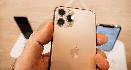 Paris, France - Sep 20, 2019: Man looking at the matte finish of the new iPhone 11 Pro displayed in...