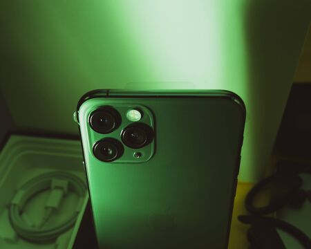 Paris, France - Sep 20, 2019: View from above of ultra-Wide, Wide, and Telephoto lenses on the new latest Apple Computers iPhone 11 Pro and 11 Pro Max smartphone triple-lens - green color castのeditorial素材