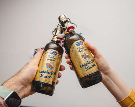 Munich, Germany - Mar 3, 2019: Male hand holding traditional Oktoberfest Marzen Pills beer against white backgroundのeditorial素材