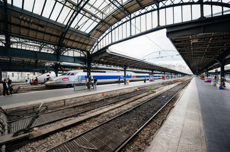 Paris, France - Jul 14, 2011: Wide angle view of Paris Gare de est train station with people tourist on the railroad platform near TGV train a grande vitesse fast trainのeditorial素材