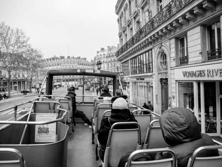 Paris, France - Jan 20, 2019: Rear view of Pa Parisian sightseeing tour bus with visitors tourists admiring the streets with cars and beautiful architectureのeditorial素材