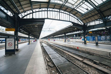 Paris, France - Jul 14, 2011: Empty Paris Gare de est train station with people tourist on the railroad platform near TGV train a grande vitesse fast trainのeditorial素材