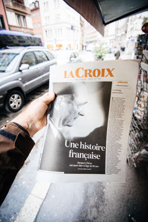 Paris, France - Sep 27, 2019: Man buying French La Croix with Jacques Chirac on cover of newspaper following the death of former French President at the age of 86 yearsのeditorial素材