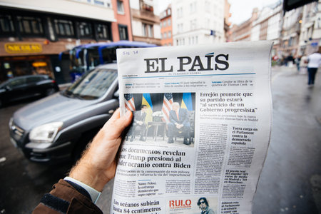Paris, France - Sep 27, 2019: Man reading newspaper in press kiosk featuring El Pais Spanish cover...
