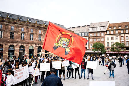 Strasbourg, France - May 18, 2019: Tamil red flag with tiger supporters people occupy square to protest against alleged human rights abuses genocide by Sri Lankan governmentのeditorial素材