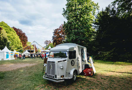 Strasbourg, France - My 5, 2019: Vintage Citroen silver food-truck in Orangerie park grass lawn during city festival serving customers in backgroundのeditorial素材