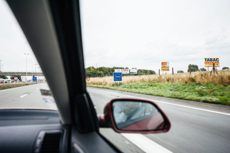 France - Jul 14, 2011: Passenger POV at the street signs at French Belgium border with signs to...
