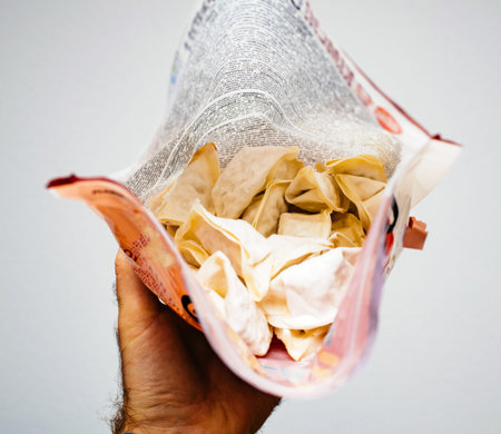Man hand holding package of frozen Jiaozi a Chinese dumpling, commonly eaten in China and other...