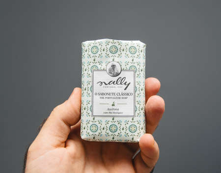Paris, France - Oct 5, 2019: Man hand holding Portuguese Sally O sabonete Classico translated as Classic Portuguese soap bar made from Olivesのeditorial素材