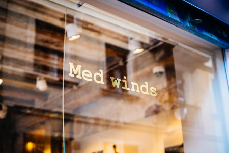 Barcelona, Spain - Nov 14, 2017: Logotype on the glass of Iconic Medietarnian Fashion store Med Winds facade. Med winds was a fashion brand for women and men, born in Barcelonaのeditorial素材
