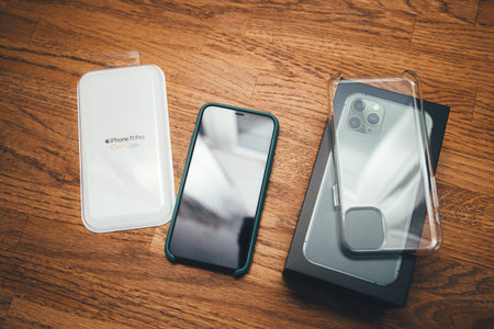Paris, France - Oct 4, 2019: View on the wooden table of the unboxing Clear Case protection for the...