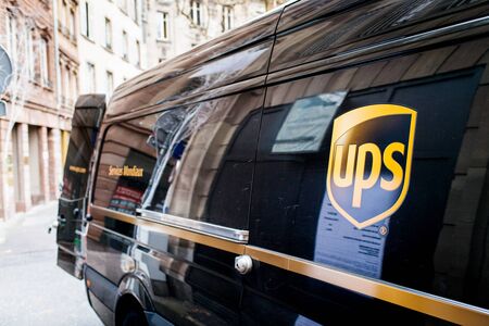 Strasbourg, France - Dec 27, 2017: Side view of UPS United parcel Service van parked on a French street with open door to deliver the parcels and e-commerce boxesのeditorial素材
