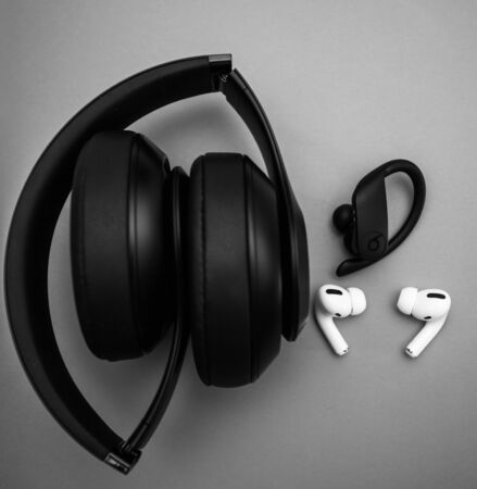 Paris, France - Oct 30, 2019: Multiple devices - new Apple Computers AirPods Pro headphones with Active Noise Cancellation for immersive sound with Powerbeats Pro by Dr Dre and Beats Studio Wirelessのeditorial素材