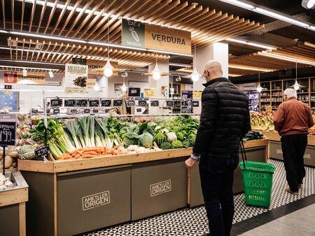 Barcelona, Spain - Nov 17, 2017: Rear view of an indecisive man choosing organic fresh vegetables in a local Catalan organic food storeのeditorial素材