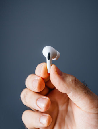 Paris, France - Oct 30, 2019: Man hand holding latest new Apple Computers AirPods Pro headphones...