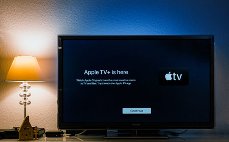 Paris, France - Nov 1, 2019: Apple TV plus is here message on living room display with try for free...