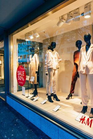 Kehl, Germany - Dec 13, 2016: Sale up to 50 percent in large H and M showcase with mannequins wearing luxury clothesのeditorial素材