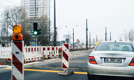 Kehl, Germany - Dec 21, 2016: Mercedes-Benz silver limousine driving on the central street under repairing in Kehl with destination Strasbourgのeditorial素材