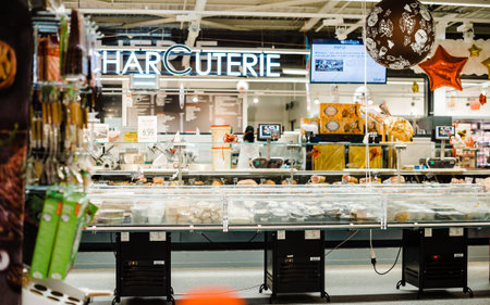 Strasbourg, France - Dec 21, 2016: Interior of large French Auchan supermarkets Charcuterie sign and...