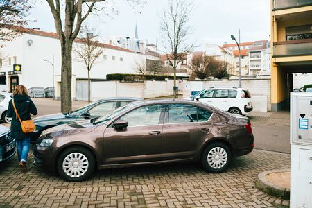 Kehl, Germany - Dec 13, 2016: Woman walking near Skoda Octavia car parked on German streetのeditorial素材