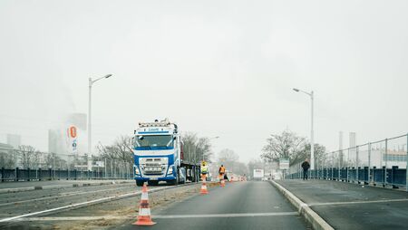 Strasbourg, France - Dec 21, 2016: Roadworks in France with half road closed and Volvo construction trucks in backgroundのeditorial素材