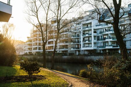 Morning view over apartment building condominiums calm lake and cinematic flareの写真素材