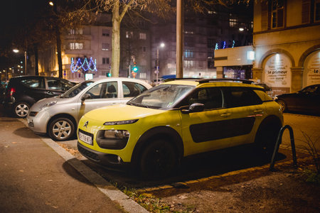 Strasbourg, France - Dec 2, 2017: Yellow Citroen Cactus car parked on French street at dusk near...
