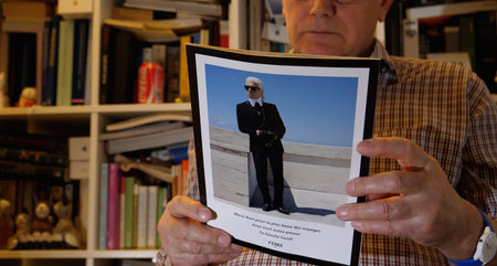Paris, France - Circa 2019: Senior man reading carefully latest number of Vanity Fair lifestyle fashion magazine with Karl Lagerfeld photo and message from Fendi familyのeditorial素材