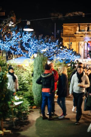 Strasbourg, France - Dec 20, 2016: Defocused silhouette of people negotiating price at the iconic Christmas Market Christkindlmarkt in Place Broglieのeditorial素材