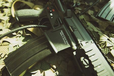 Paris, France - Sep 21, 2019: Detail of semi-automatic rifle manufactured by German Heckler and Koch GmbH - military pattern backgroundのeditorial素材
