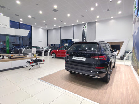 Paris, France - Oct 25, 2019: Wide angle view of car dealership showroom interior with multiple...