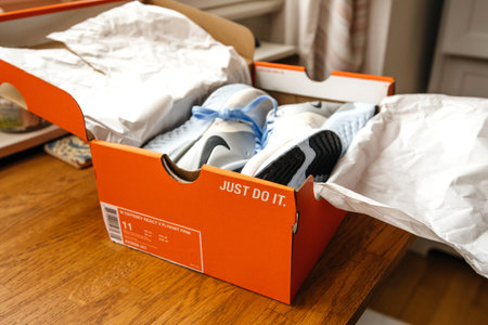 Paris, France - Sep 23, 2019: Unboxing unpacking on wooden table pair of new Nike female running...