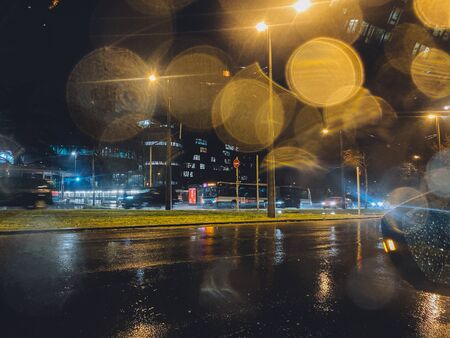 Strasbourg, France - Dec 11, 2019: Driving in the rainy weather Cinematic bokeh on the glass with silhouettes of cars driving in background on a rainy day in Franceのeditorial素材