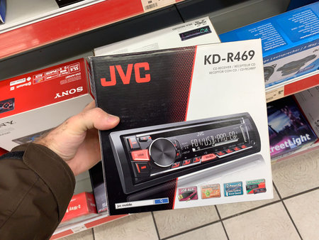 Dortmund, Germany - Mar 25, 2019: Man customer hand holding package of new auto radio manufactured...